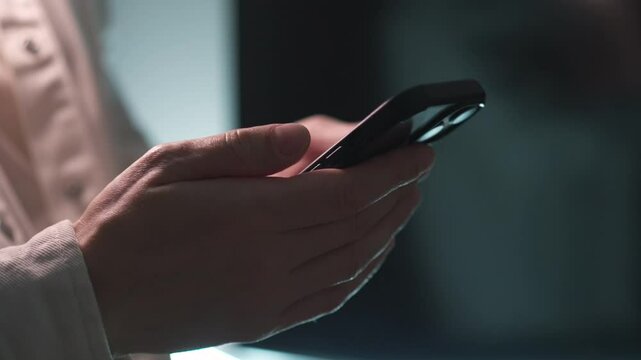 A man in a light shirt touches the phone screen.
A man with a large phone in his hands.
A businessman writes an SMS on his phone and scrolls through a social media feed.
