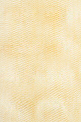 Sweater or scarf fabric texture large knitting. Knitted jersey background with a relief pattern. Wool hand- machine, handmade, yellow.