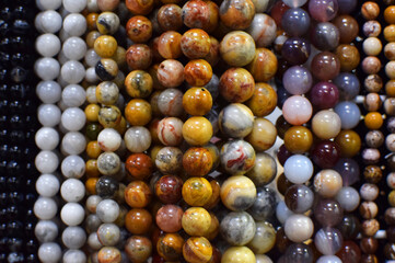 Strands of colorful natural agate beads at the gemstone market.