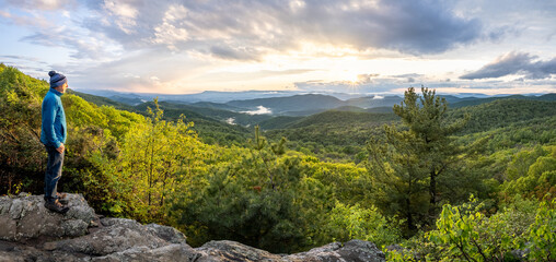 A person, man looking at the setting sun, Blue Ridge Mountains, Grindstone Mountain, Powel Mountain, The Point Overlook, Shenandoah National Park, Virginia