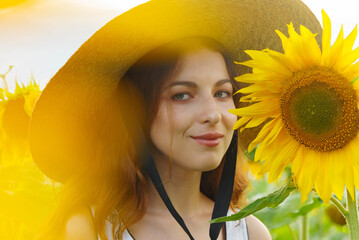 Portrait of a pretty girl in a field of sunflowers.