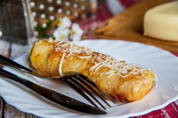 Savory fried pancakes with ham and cheese, crepes filled with ham and cheese
