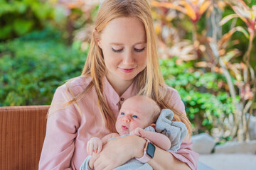 A mother lovingly embraces her newborn baby, holding them close to her chest. A tender moment of...
