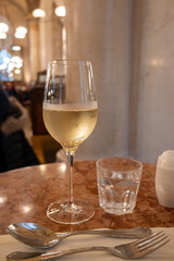 Lifestyle of beautiful Vienna, glass of cold white dry Austrian wine served in old Viennese-style cafe in Vienna, Austria