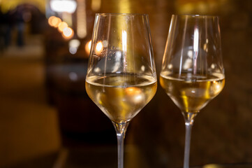 Visit of wine cellar, tasting of brut champagne sparkling wine produced by traditional method in underground caves close up