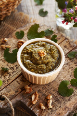 Green pesto sauce made of young garlic mustard leaves - wild edible plant collected in early spring