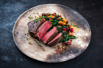 Barbecue dry aged beef steak - roast beef medium english roasted, sliced with wild mushrooms, chetnuts, greens and cranberries