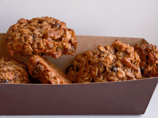 oatmeal cookies with prunes in a cardboard box, copy space, mockup