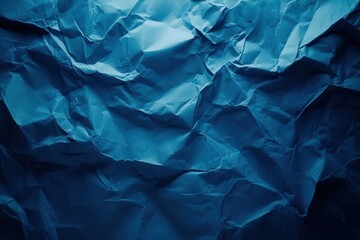 Obraz premium Abstract blue crumpled paper background featuring a textured surface, ideal for themes of creativity, chaos, or artistic design.