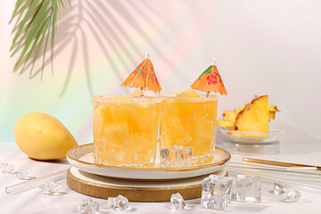 Cold frozen punch made from pineapple slices and ice cubes. Pineapple alcoholic cocktail in glasses...