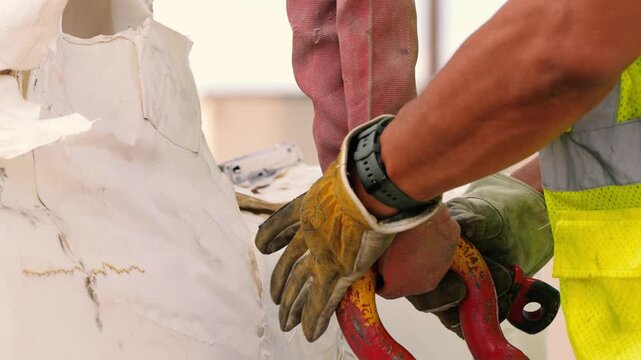 Gloved hands attaching D-ring bolt to mount