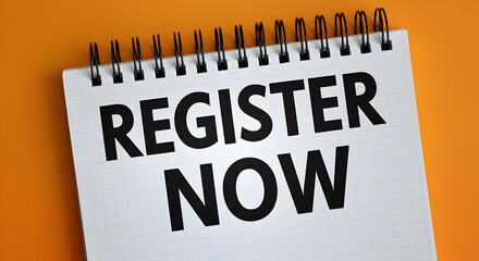 Register Now Text on Spiral Notebook Placed on Vibrant Orange Background for Call to Action