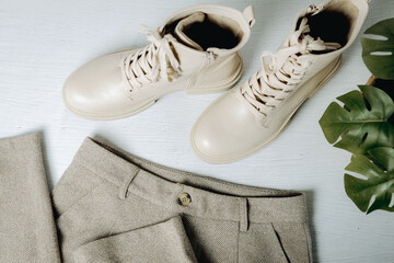 Beige boots with trousers on a light background.