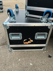 Loading or Unloading incident: road cases fell off a truck trailer at an industrial site