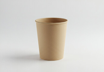 Empty kraft paper coffee cup isolated on white background, eco-friendly disposable container for hot beverages with smooth beige surface and rolled rim design.