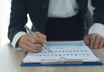 Auditor businesswoman checking, auditing business document, analyzing financial report, sale data...