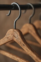 Wooden hangers showcase ethical slow fashion choices in minimalist setting