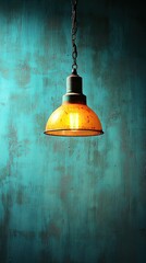 Obraz premium Lit amber lamp hangs before distressed turquoise wall, creating moody atmosphere