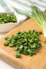 Cut fresh green onions on table, closeup