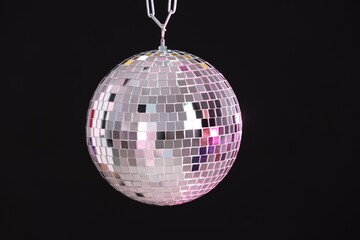 One shiny disco ball on black background