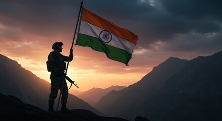 Silhouette of a soldier holding the Indian flag atop a mountain at sunset