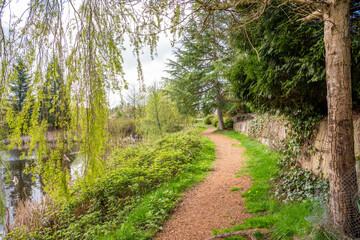 Park with small pond and path at summer day in Vancouver, Canada, North America. Day time on April 2025.