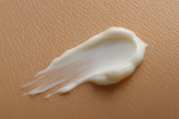 Naklejka premium Cream texture applied on skin surface 