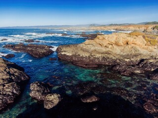 Coastal landscape of Glass Beach, Fort Bragg, California, USA. Waves crash against the rocky...