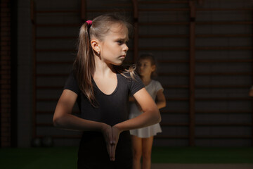 Training of children in the gym. Gymnastics, circus, fitness for girls.