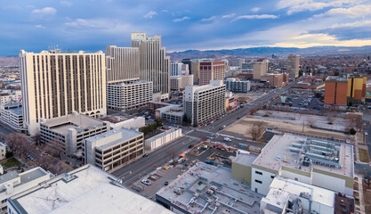 Aerial view of downtown Reno, Nevada, USA, showcasing the city's architecture and urban landscape. The image captures the city's skyline, streets, and surrounding mountains.