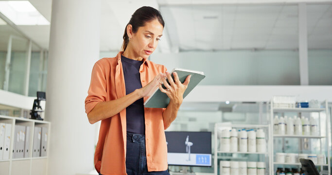 Tablet, typing and business woman in office for Sustainability advisor, carbon footprint policy and research. Windmill design, environment report and review with person in agency for project manager