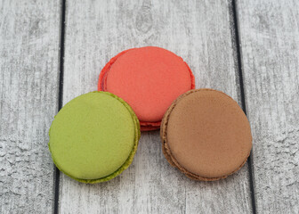 Macaroons lie on a wooden background