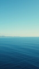 Obraz premium The water glistens in vibrant shades of blue, reflecting the clear sky above. Gentle ripples create a mesmerizing pattern, enhancing the tranquil beauty of the scene.