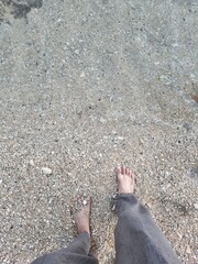 Enjoying Nature’s Calm, Feet Beneath Crystal Clear Water