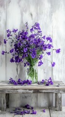 Fototapeta premium Purple flowers in glass jar, rustic wood setting.