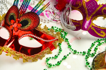 Beautiful carnival masks with confetti and decor on white background. Closeup