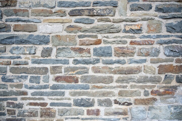 A wall made of stone and gray bricks