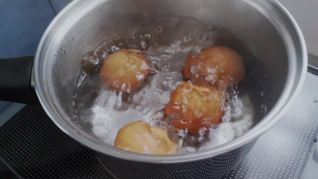 Boiled eggs with hot water in a pot