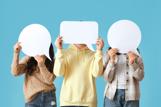 Young people with blank speech bubbles on blue background