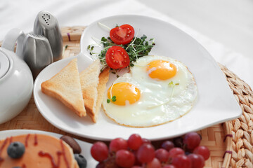 Tasty breakfast for Valentine's Day on pouf in bedroom, closeup