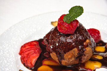 Fried ice cream, fried ice cream dessert with strawberries and covered in chocolate on a white background