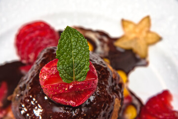 Fried ice cream, fried ice cream dessert with strawberries and covered in chocolate on a white background