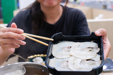 Sliced ​​pork belly on a black tray for serving shabu