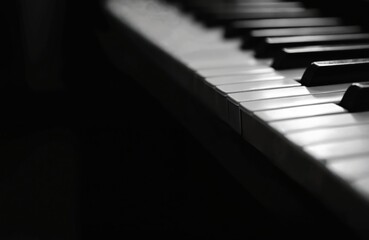 Piano keys in the dark. Black and white piano keyboard. Close-up view of musical instrument. Music concept, classical instrument. Dark background. Musical performance. Harmony of music.