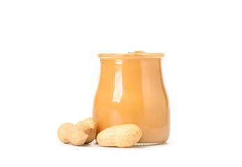 Jar with tasty peanut butter and nuts on white background
