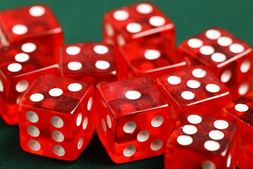 Red game dices on green background, closeup