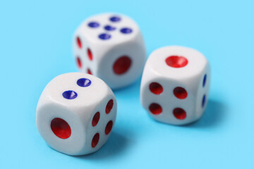 Dices with red and blue pips on blue background, closeup