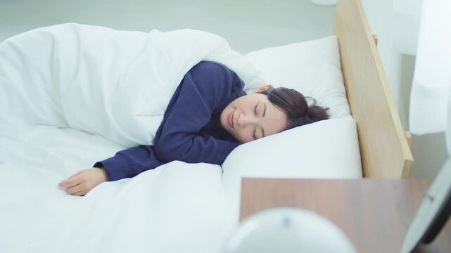 ベッドで寝ている女性