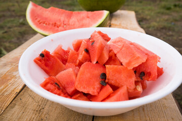 White plate with red watermelon. Fresh harvest of berries, vegetables and fruits. High quality photo