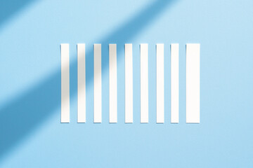 Obraz premium Set of white paper strip notes with shadows on blue background